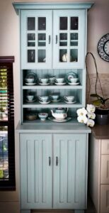 Antique style kitchen cupboard with tea-pots