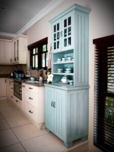 Antique style kitchen cupboard with tea-pots