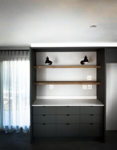 Modern kitchen cupboards next to glass door