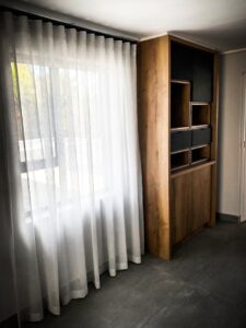 Modular cupboard next to window