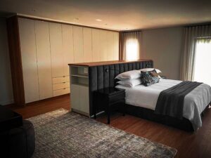 White bedroom cupboards with side table