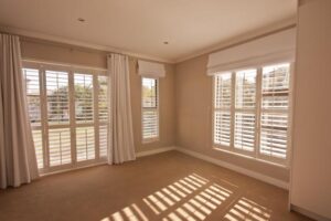 Clean bedroom with light shining through windows