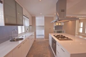 Modern kitchen cupboards with island unit and glass doors